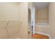 Functional walk-in closet with ample shelving leading into a bright bathroom with a soaking tub at 2813 Jasmine St, Denver, CO 80207