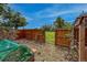 Gated backyard with an arbor, fenced yard, and raised garden beds at 117 Sandler Dr, Lafayette, CO 80026