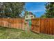 Wooden backyard gate that leads to green space and open grassy field at 117 Sandler Dr, Lafayette, CO 80026