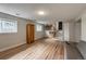 View of a basement room including built in cabinets, seating, and access to the main floor at 117 Sandler Dr, Lafayette, CO 80026