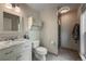 Bright bathroom featuring marble countertop, updated vanity, toilet, and a glass enclosed tile shower at 117 Sandler Dr, Lafayette, CO 80026