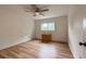 Bedroom with hardwood floors, ceiling fan and a window looking out to a green space at 117 Sandler Dr, Lafayette, CO 80026