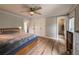 Bedroom with a ceiling fan, hardwood floors, an ensuite bathroom, and built-in closet at 117 Sandler Dr, Lafayette, CO 80026