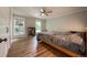 Bright bedroom featuring hardwood floors and large windows overlooking the outside landscape at 117 Sandler Dr, Lafayette, CO 80026