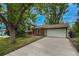 Charming home featuring a long driveway, brick accents, well-maintained lawn, and mature trees at 117 Sandler Dr, Lafayette, CO 80026