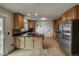 Well-lit kitchen with stainless steel appliances, granite countertops, and light wood cabinets at 117 Sandler Dr, Lafayette, CO 80026
