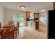 Bright kitchen featuring wood cabinets, granite countertops, and a sliding glass door to the backyard at 117 Sandler Dr, Lafayette, CO 80026