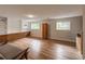 Comfortable living room with built in cabinets, neutral walls, and hardwood floors at 117 Sandler Dr, Lafayette, CO 80026