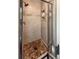 Close up of shower with tile, shampoo niches and brown mosaic tile flooring in shower at 117 Sandler Dr, Lafayette, CO 80026
