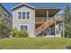 Exterior of a two-story home with an open, raised deck accessible via wooden stairs from the well-manicured backyard at 11096 Endeavor Dr, Parker, CO 80134