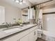 Modern bathroom with double sink vanity, sleek fixtures, and a tiled shower-tub combo for relaxation at 11096 Endeavor Dr, Parker, CO 80134