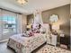 Cozy bedroom with a bright window, neutral walls, and stylish decor for a comfortable living space at 11096 Endeavor Dr, Parker, CO 80134