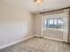 Simple bedroom with neutral walls, soft carpet, and a window overlooking the neighborhood at 11096 Endeavor Dr, Parker, CO 80134