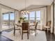 Dining area with hardwood floors, large windows, and sliding door with access to an outdoor deck at 11096 Endeavor Dr, Parker, CO 80134