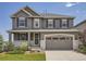 Charming two-story home featuring a covered front porch, gray exterior, and well-maintained landscaping at 11096 Endeavor Dr, Parker, CO 80134