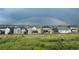 Suburban homes sit beneath a vibrant rainbow arching across the sky at 11096 Endeavor Dr, Parker, CO 80134