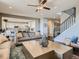 Spacious living room featuring a modern layout with hardwood floors, comfortable seating, and open access to the kitchen at 11096 Endeavor Dr, Parker, CO 80134