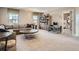 Spacious living room with neutral carpet, lots of natural light, and open access to other rooms at 11096 Endeavor Dr, Parker, CO 80134