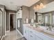 Main bathroom offering a dual vanity, open walk-in closet, and luxurious finishes at 11096 Endeavor Dr, Parker, CO 80134