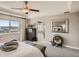 Spacious main bedroom boasting a ceiling fan, adjacent bathroom, and beautiful views at 11096 Endeavor Dr, Parker, CO 80134