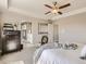 Main bedroom featuring ensuite bathroom, ceiling fan, neutral walls, and a dark wood dresser at 11096 Endeavor Dr, Parker, CO 80134