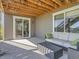 Covered patio with comfortable seating, a modern coffee table, and direct access to the home's interior at 11096 Endeavor Dr, Parker, CO 80134