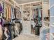 Spacious walk-in closet with built-in shelving, drawers, and ample hanging space for organized storage at 11096 Endeavor Dr, Parker, CO 80134