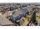 Aerial view of a gray two-story home with a fenced backyard and covered patio in a residential neighborhood at 8783 S Carr Way, Littleton, CO 80128