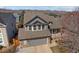 Aerial view of home with a well-maintained roof, landscaping, and mountain backdrop at 8783 S Carr Way, Littleton, CO 80128