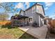 Backyard with deck, patio, grill, and well-maintained lawn at 8783 S Carr Way, Littleton, CO 80128