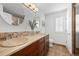Bathroom featuring dual sinks, a neutral color palette, and round mirrors at 8783 S Carr Way, Littleton, CO 80128
