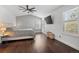 Bright bedroom featuring a ceiling fan, large windows, and hardwood floors at 8783 S Carr Way, Littleton, CO 80128