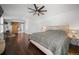Relaxing bedroom featuring a barn door that goes to the bathroom, hardwood floors, and decor at 8783 S Carr Way, Littleton, CO 80128