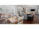 Dining area with a table set for a meal, connected to the kitchen and living room at 8783 S Carr Way, Littleton, CO 80128