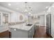 Spacious kitchen featuring a large island with granite countertops and stainless steel appliances at 8783 S Carr Way, Littleton, CO 80128