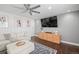 Comfortable living room with modern decor, a large TV, and hardwood floors at 8783 S Carr Way, Littleton, CO 80128