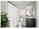 Well-lit bathroom with a shower and tub featuring a stylish vanity and modern fixtures for a relaxing experience at 2620 S Delaware St # 3, Denver, CO 80223