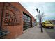 Public Offering brewery with exposed brick and an inviting large glass door at 2620 S Delaware St # 3, Denver, CO 80223