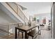 Open dining area featuring a modern table with seating, staircase, and access to the living room at 2620 S Delaware St # 3, Denver, CO 80223