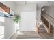 Welcoming entryway featuring a staircase, storage closet, modern decor, and wood floors at 2620 S Delaware St # 3, Denver, CO 80223