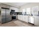 Modern kitchen with stainless steel appliances, white cabinets, and a stylish backsplash at 2620 S Delaware St # 3, Denver, CO 80223