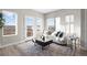 Bright living room featuring a comfortable sofa, stylish coffee table, and large windows with natural light at 2620 S Delaware St # 3, Denver, CO 80223