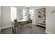 Bright home office with modern desk, shelving, and ample natural light, providing an inspiring workspace at 2620 S Delaware St # 3, Denver, CO 80223