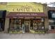 The storefront of Capital Tea, featuring tables outside and signage indicating teas, treats, and sandwiches at 2620 S Delaware St # 3, Denver, CO 80223