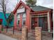 The exterior of Chiva Colombian Cuisine shows a red brick building with black trim and a welcoming entrance at 2620 S Delaware St # 3, Denver, CO 80223