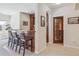 Charming bar area with ample seating and beautiful glass door leading to a wine cellar at 4619 Mohawk Dr, Larkspur, CO 80118