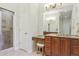 Bathroom vanity featuring granite counters, wood cabinets, a makeup area, and a glass shower enclosure at 4619 Mohawk Dr, Larkspur, CO 80118
