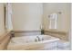 Relaxing soaking tub featuring a tile surround and decorative fixtures, providing a serene bathing experience at 4619 Mohawk Dr, Larkspur, CO 80118