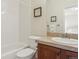 Bathroom featuring a shower/tub combination, white tiling, decorative mirror, and granite countertop at 4619 Mohawk Dr, Larkspur, CO 80118