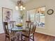 Cozy breakfast nook with a glass-top table and chairs near a window at 4619 Mohawk Dr, Larkspur, CO 80118